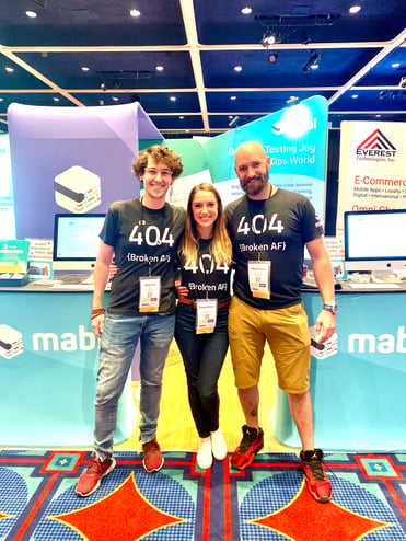 3 mabl employees at a conference, standing in front of the mabl booth.