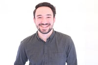 Thomas has dark brown hair and is wearing a black shirt. He is a junior product manager at mabl.