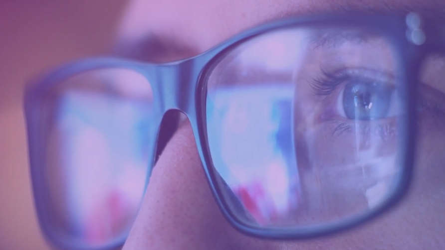 A closeup of a man's eyes while wearing glasses.