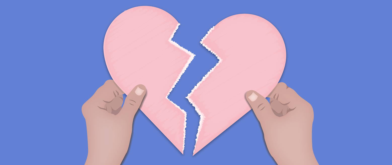 Hands holding 2 pieces of a broken heart.