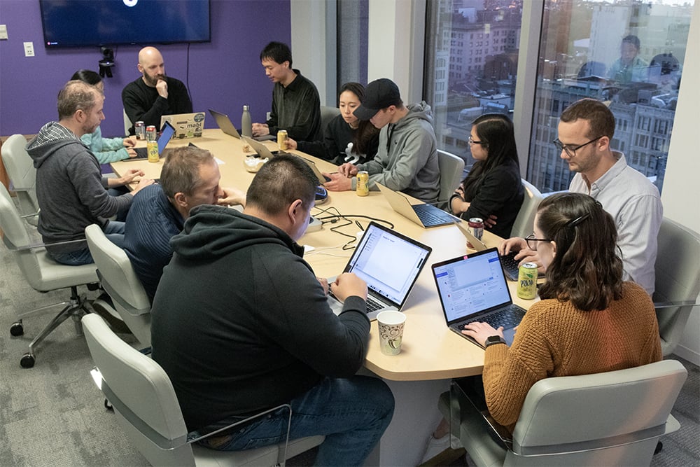 A group of mabl employees working around a conference table.